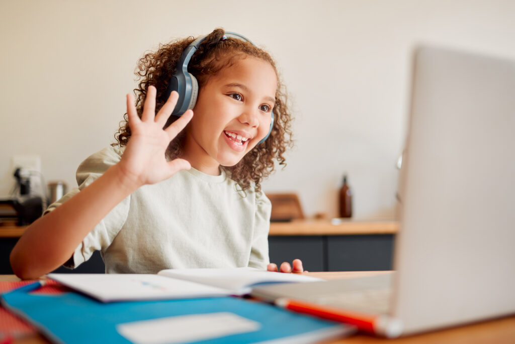 Blended Learning - Online, distance learning child on laptop webcam or video call joining lesson with headphones and h